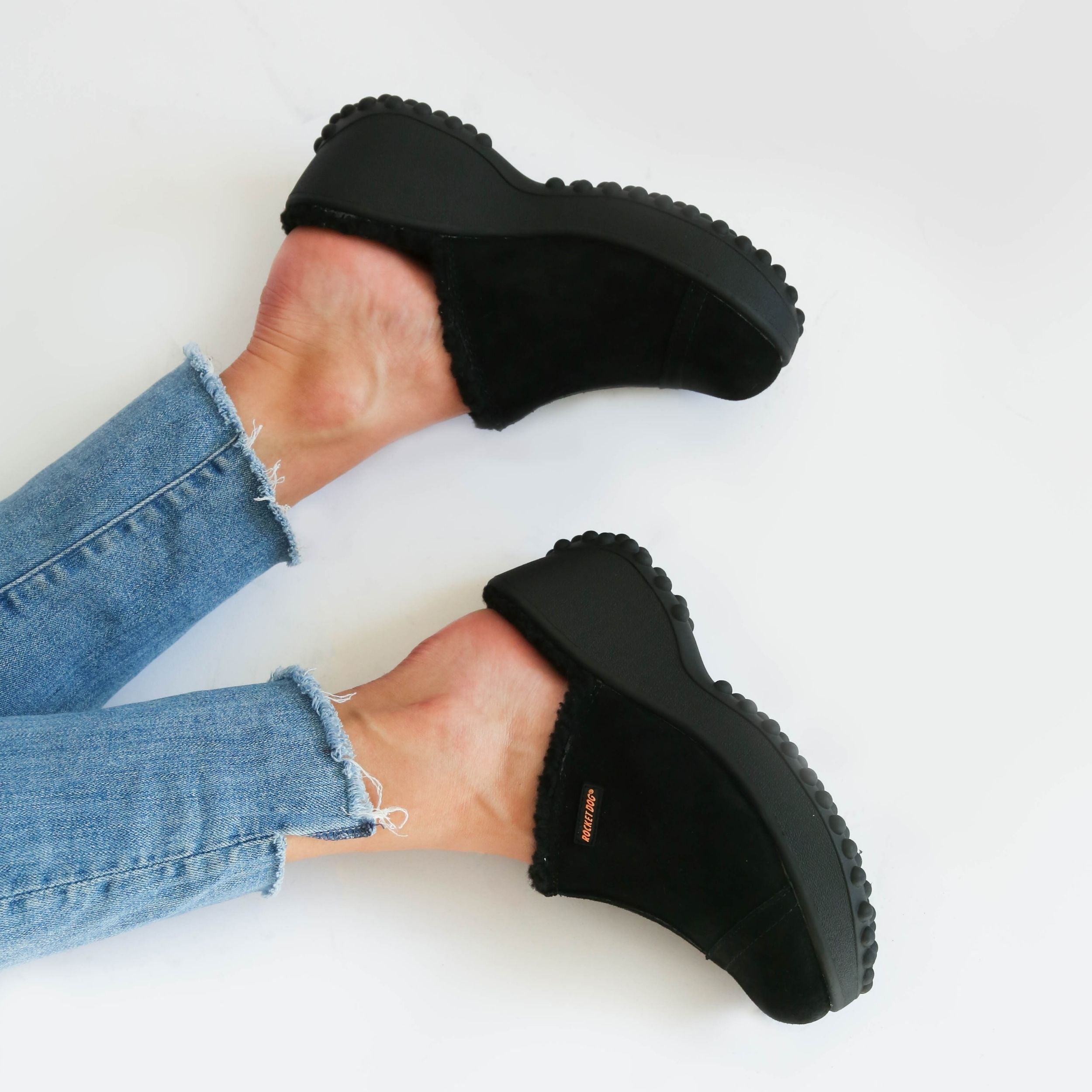 Black fuzzy platform clogs styled with distressed denim jeans, casual everyday look – Rocket Dog Fran